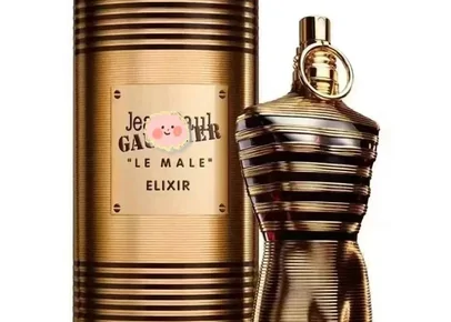 Goldfarbener Parfumflakon neben seiner Dose